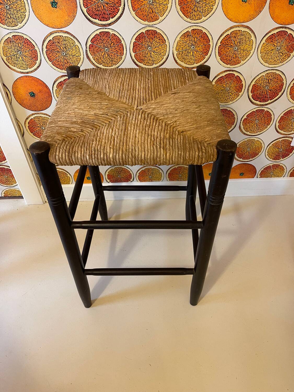 High stool made of wood and straw
