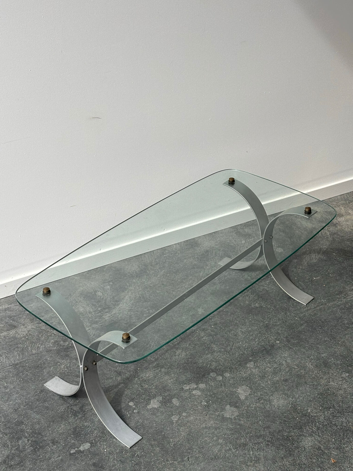 Design coffee table in brushed metal with a glass top, 1970s.