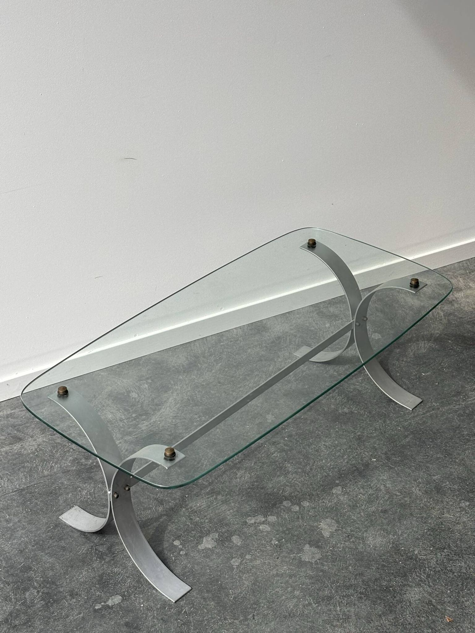 Design coffee table in brushed metal with a glass top, 1970s.