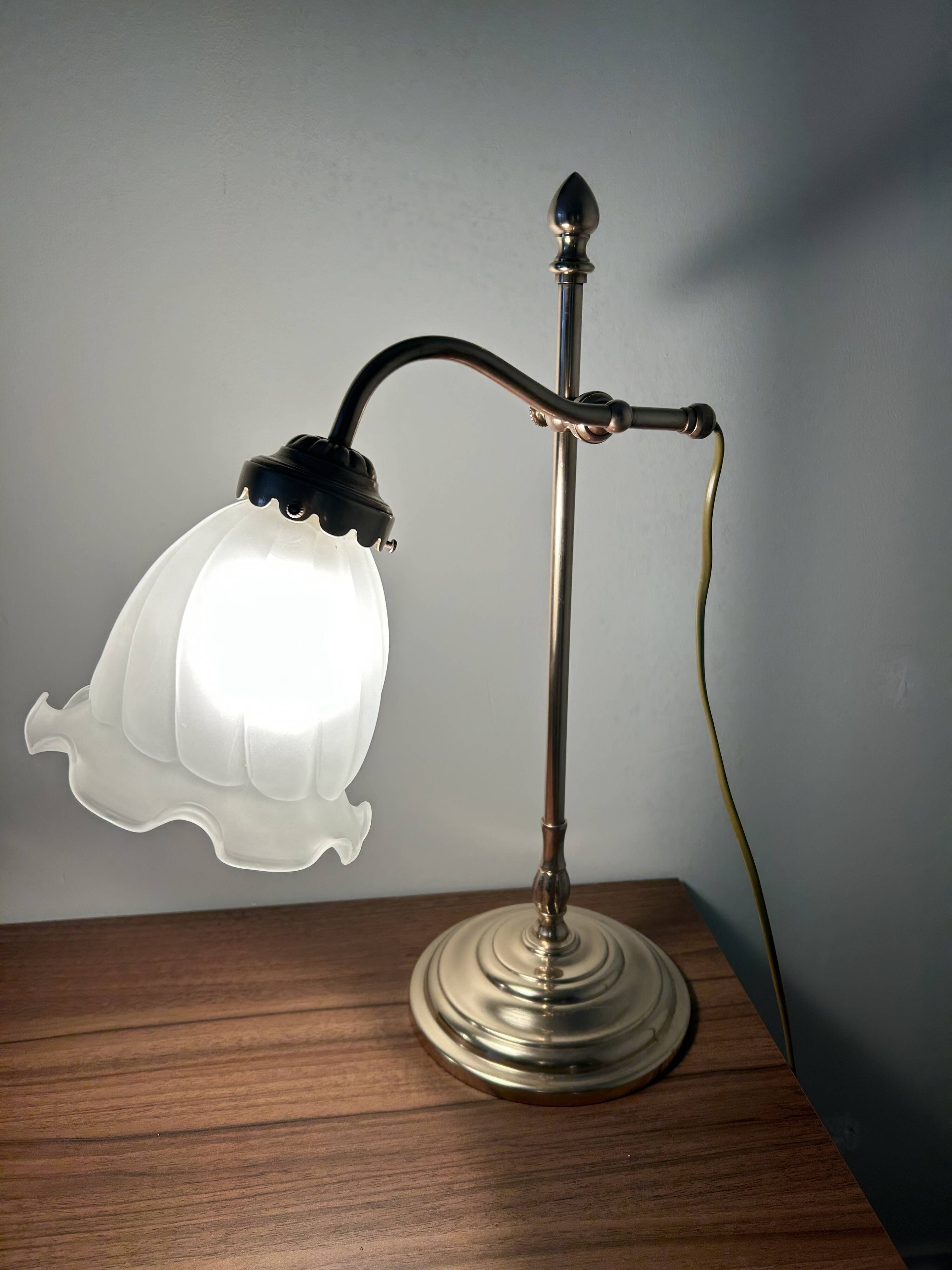 Articulated brass lamp with glass shade, early 20th century.