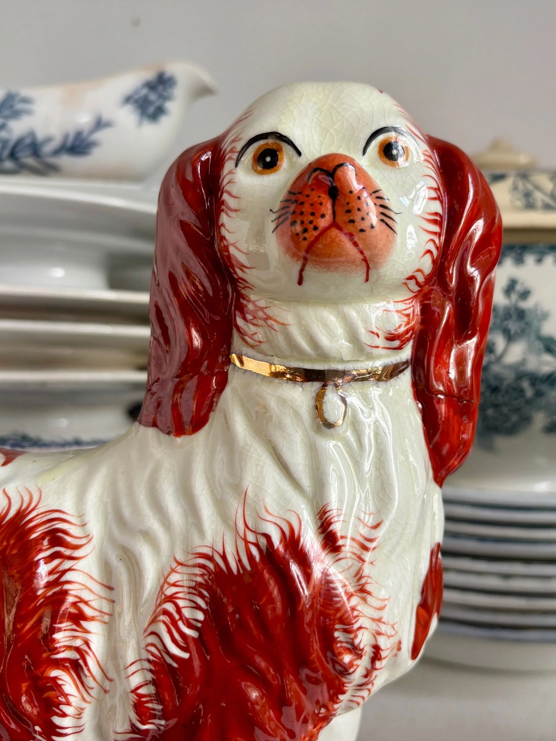 Pair of Staffordshire porcelain Cavalier King Charles dogs on terrace, 19th century.