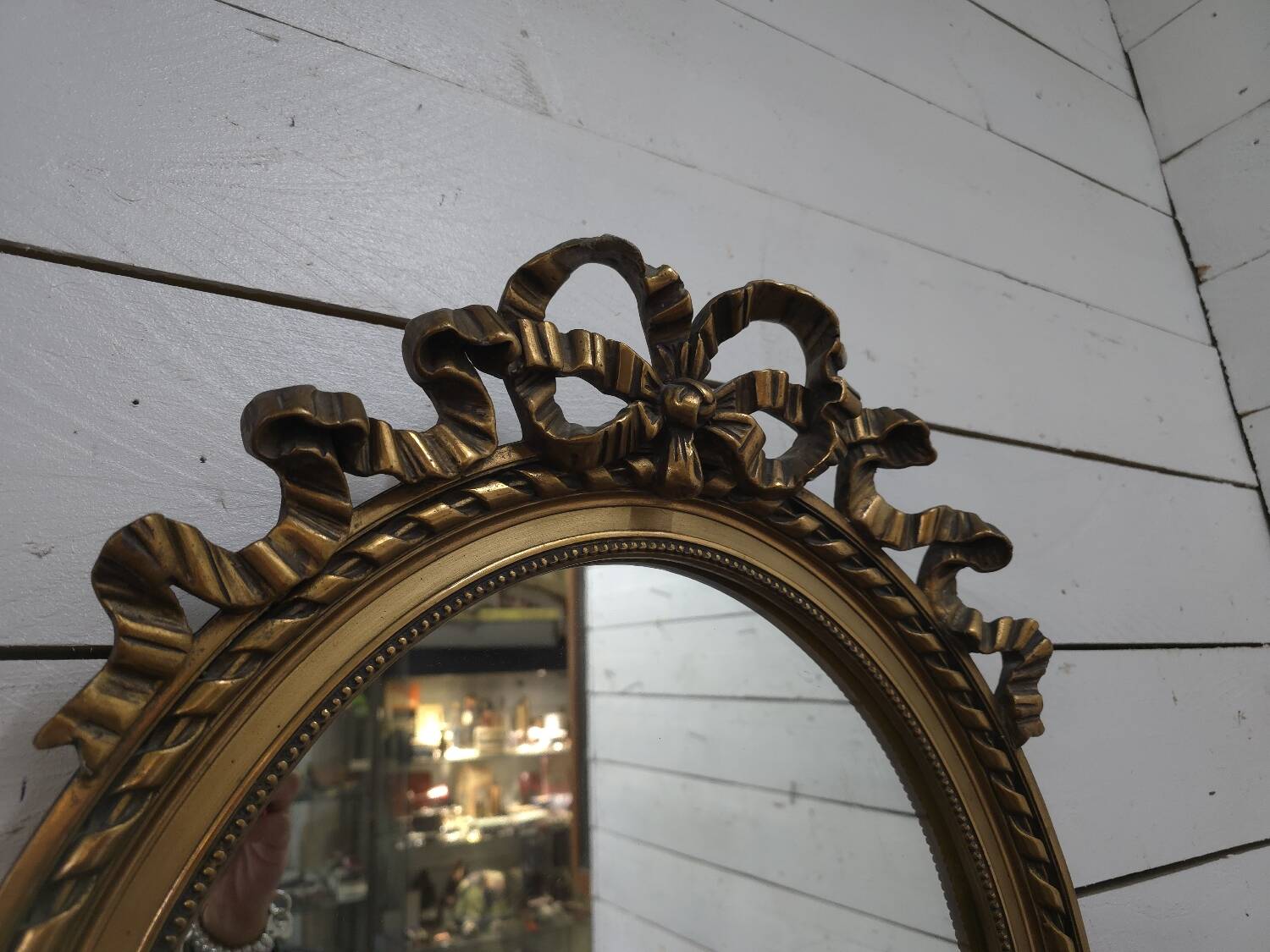 Oval mirror with gold patina