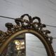 Miroir ovale patiné doré