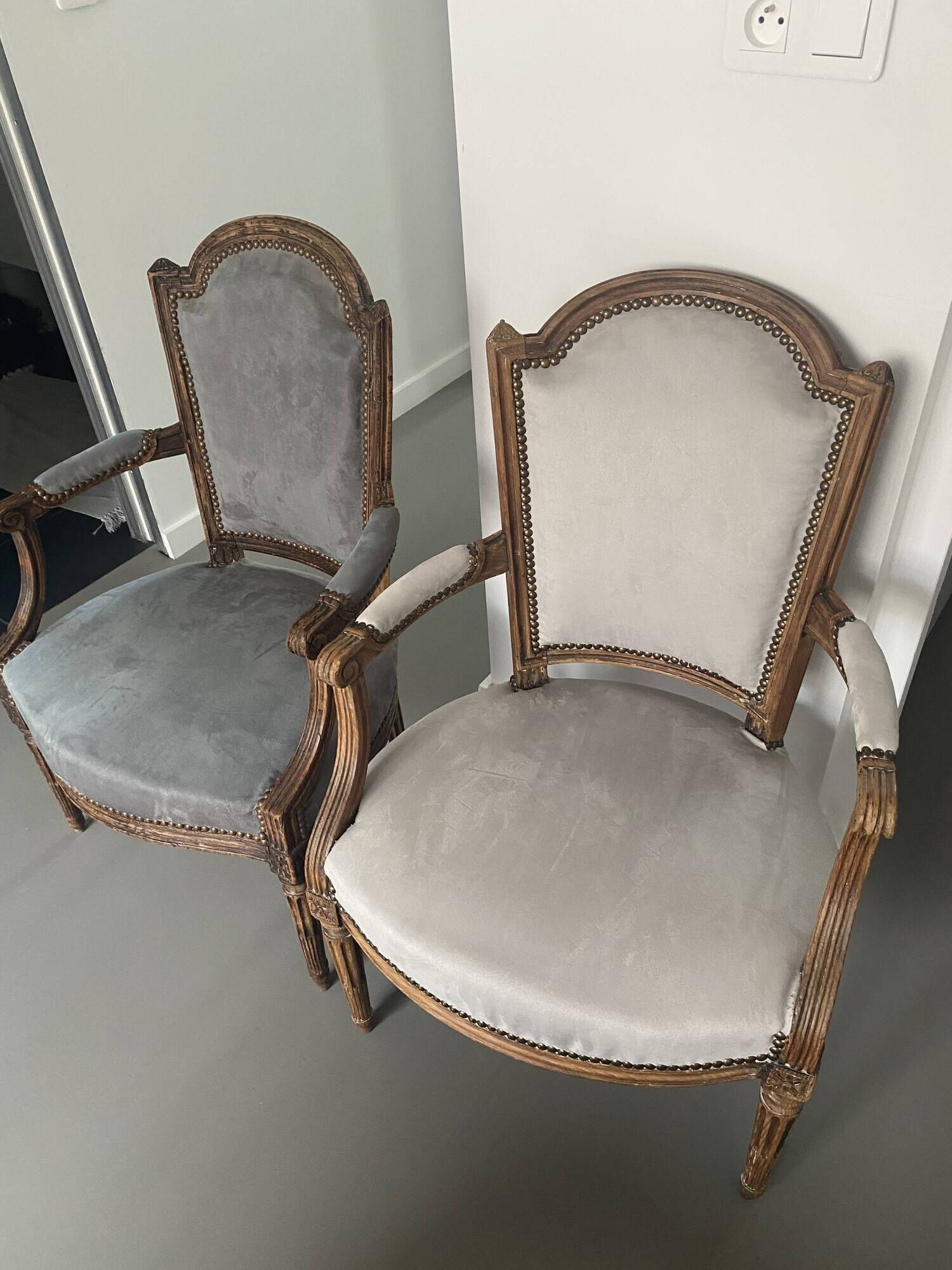 Pair of cabriolet armchairs in light grey and dark grey Louis XV style.