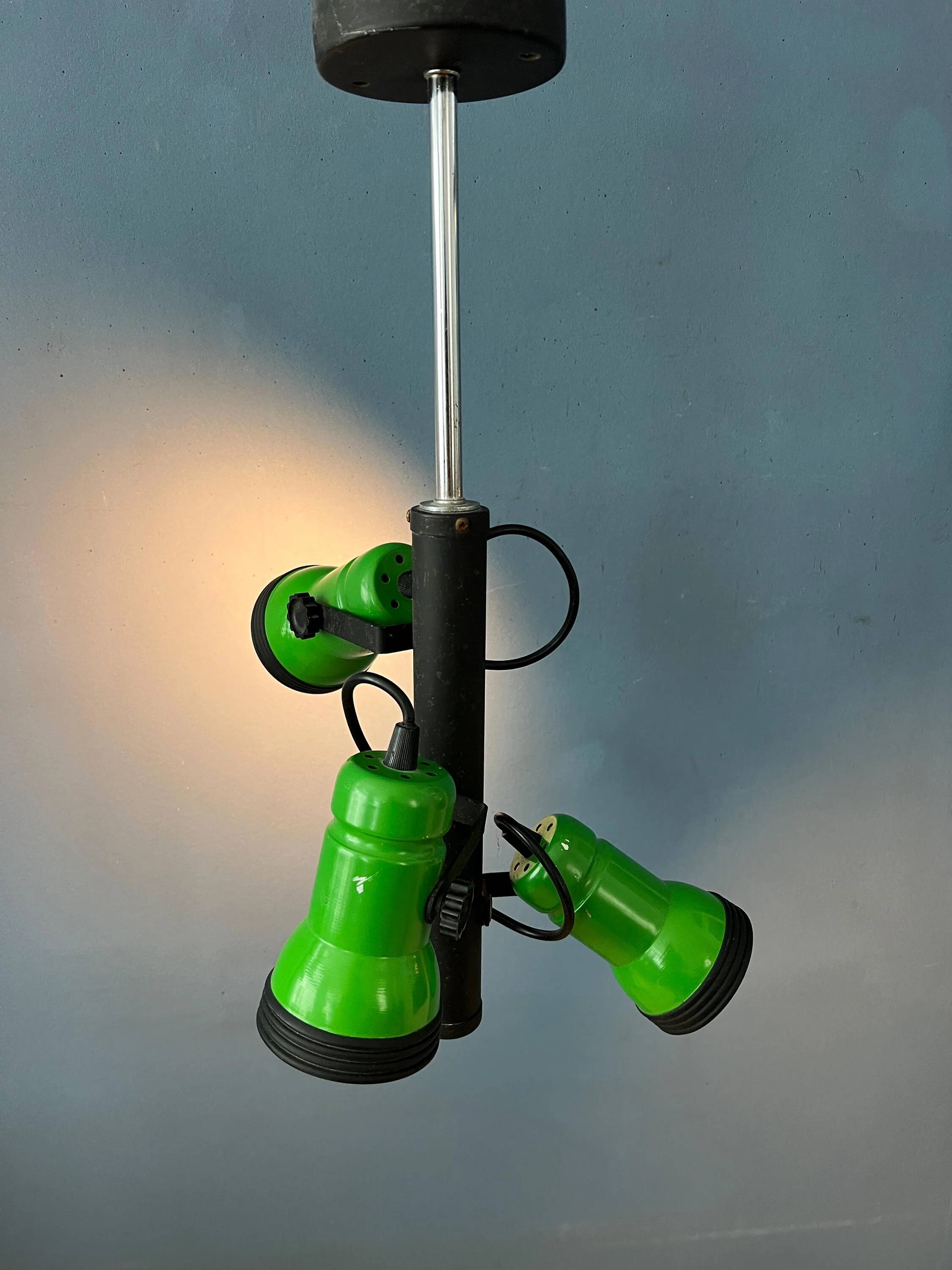 Vintage pendant light with three green spots.