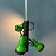 Vintage pendant light with three green spots.