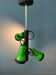 Vintage pendant light with three green spots.