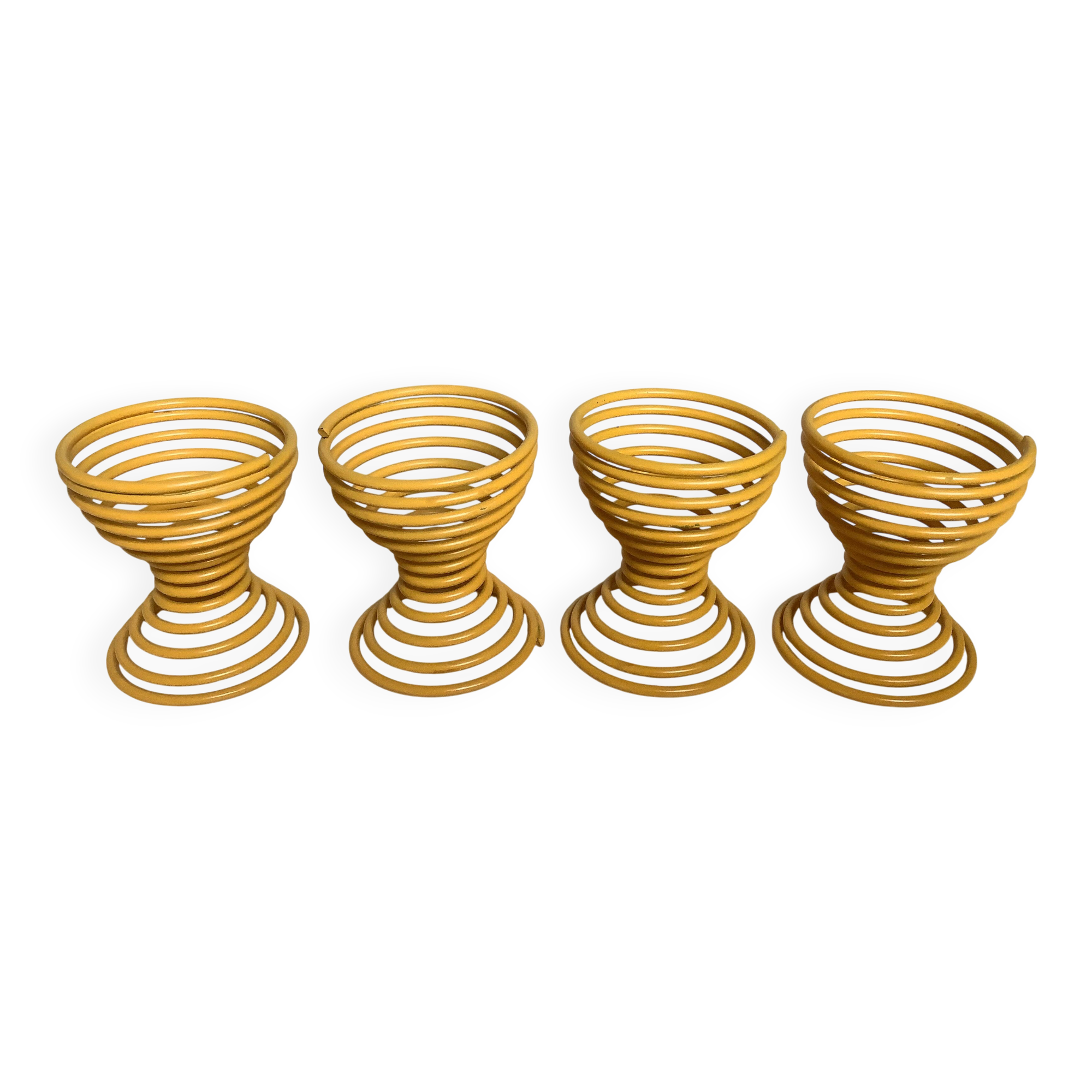 Four yellow spiral spring egg cups