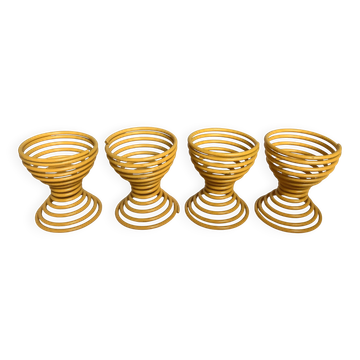 Four yellow spiral spring egg cups