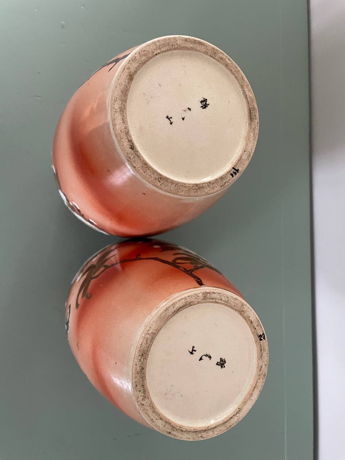 Pair of antique vases with butterfly and flower motif.