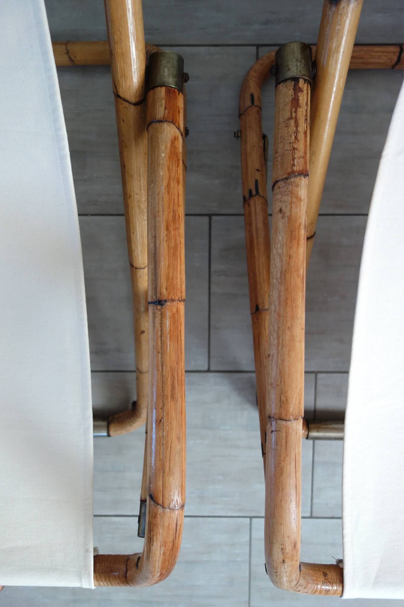 Pair of folding bamboo and brass deck chairs, Italy, 1960s.