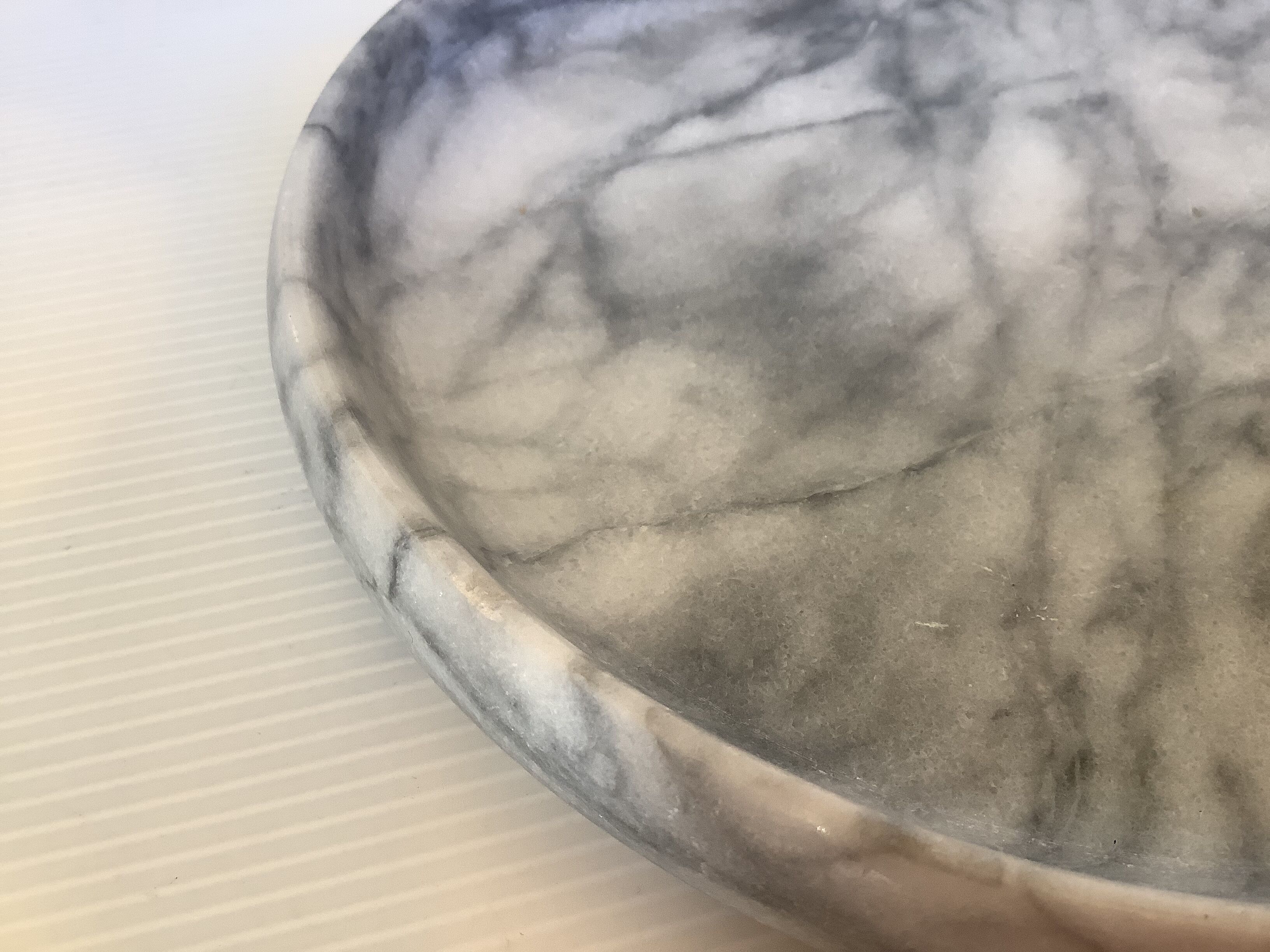 Empty round pocket in gray marble