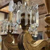 Golden wooden chandelier with crystal pendants from the 19th century.