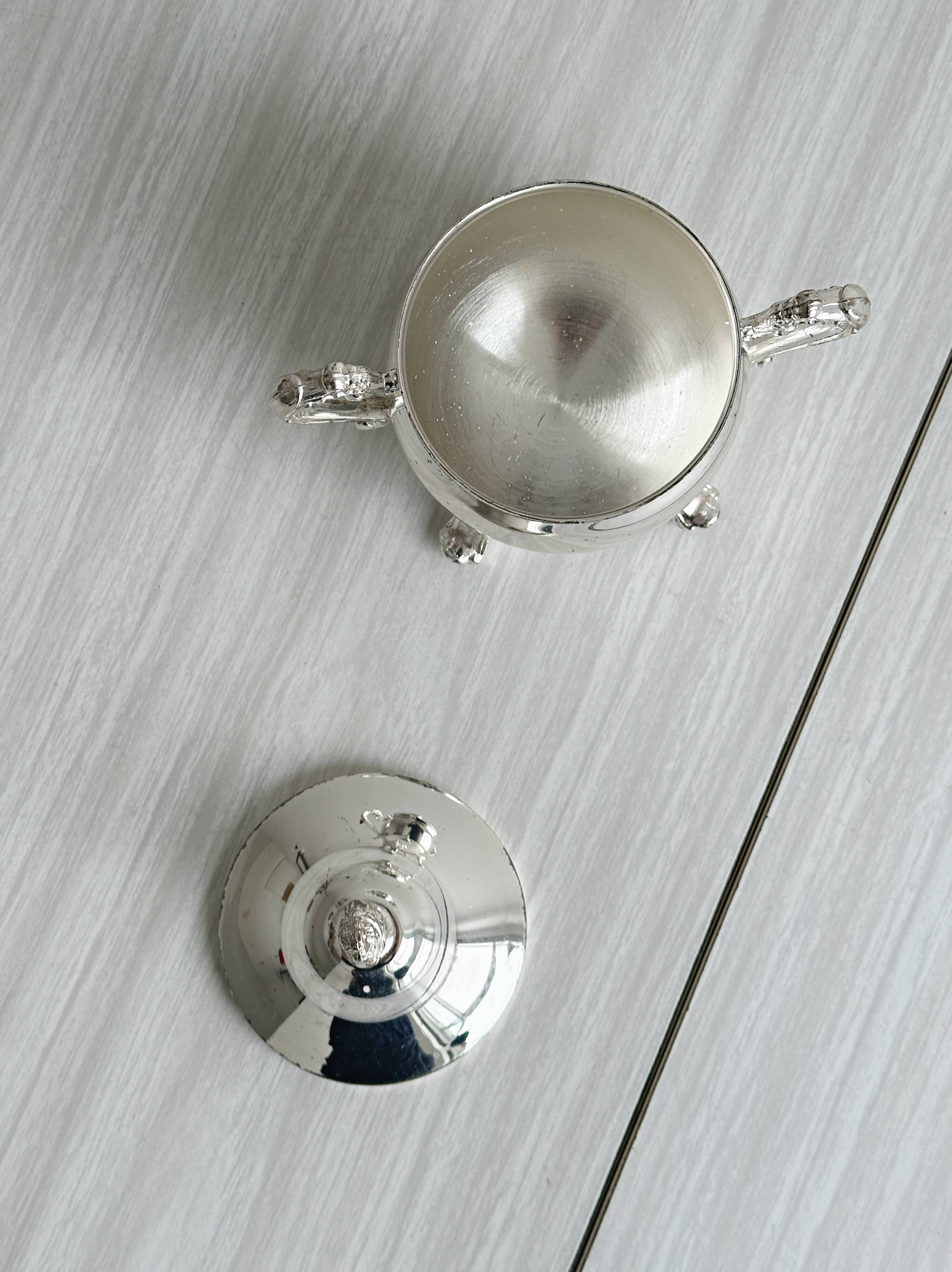 Antique shiny metal sugar bowl