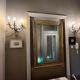 Pair of Louis XV style wall lights, rocaille with three branches in bronze.