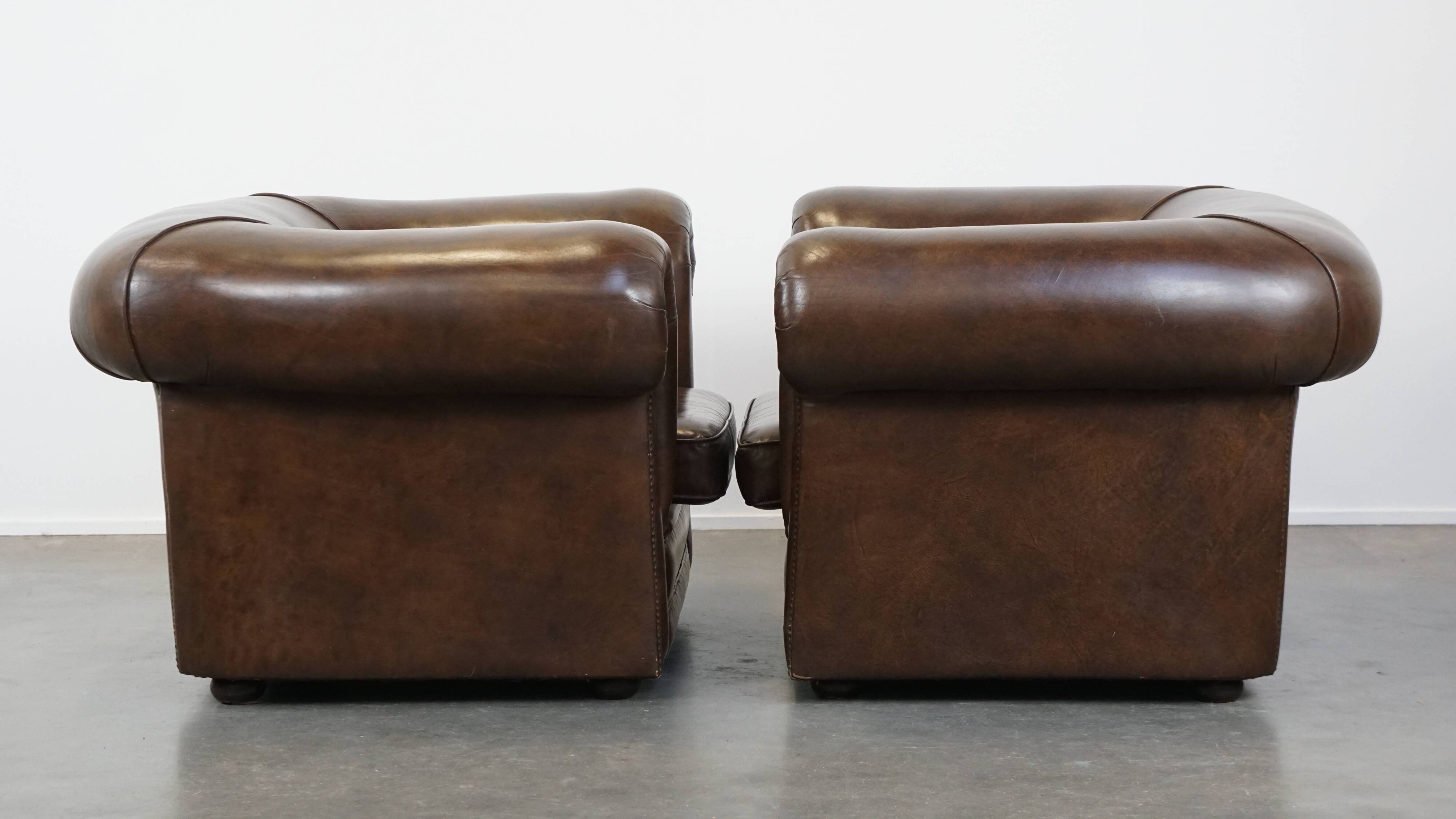 2 Chesterfield armchairs in dark brown cowhide