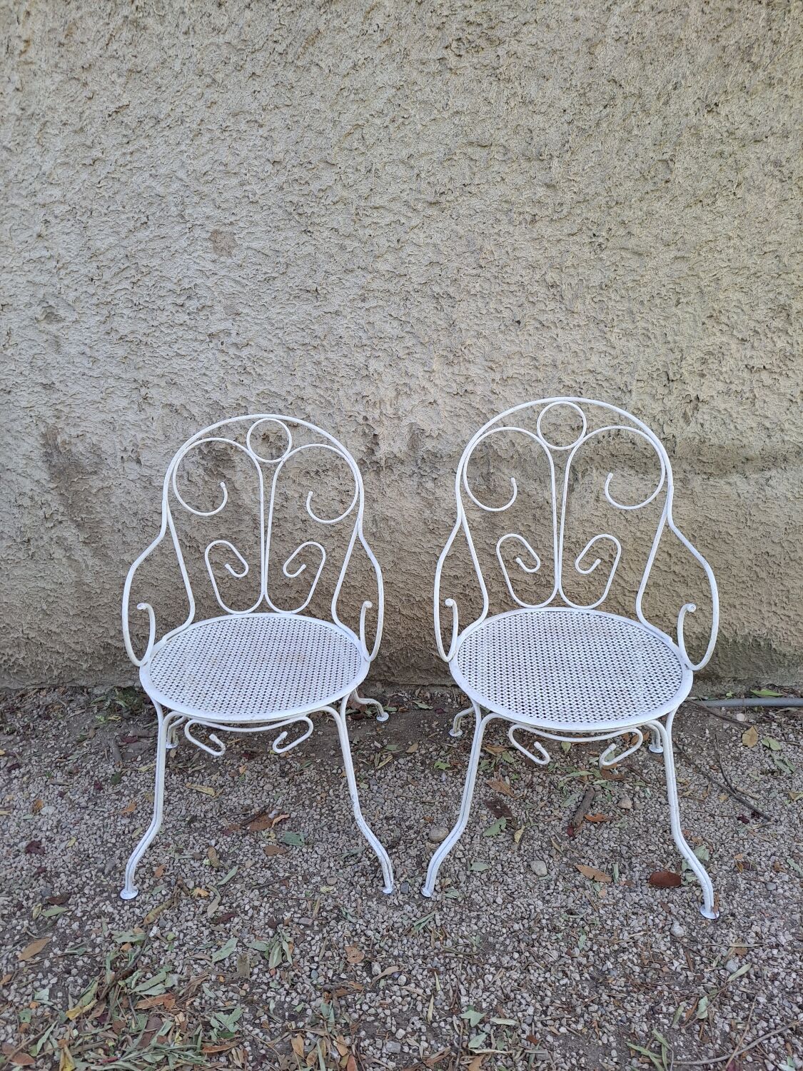 Pair of old white iron armchairs