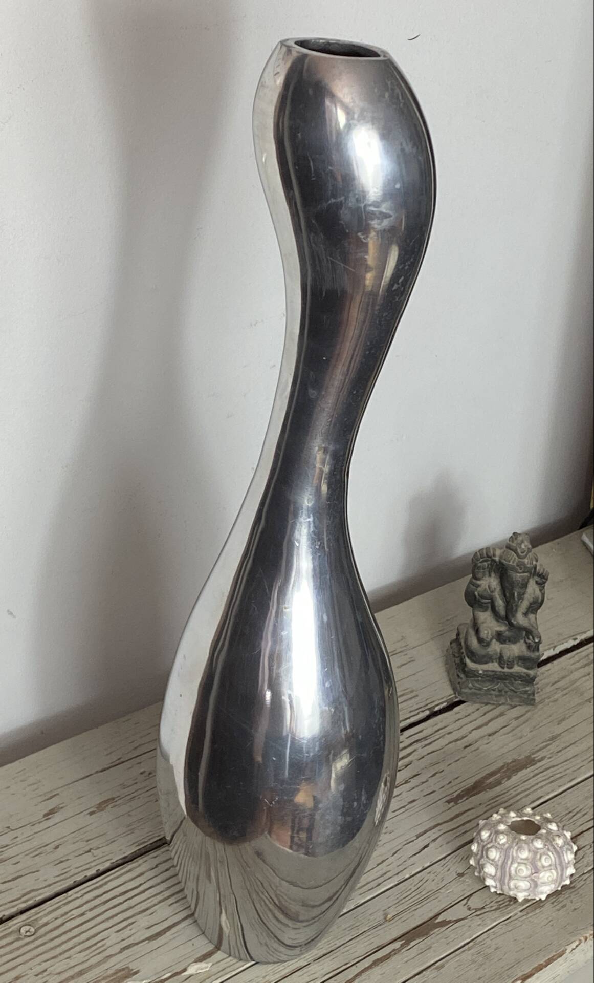 Large organic vase in polished aluminium cast.