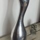 Large organic vase in polished aluminium cast.