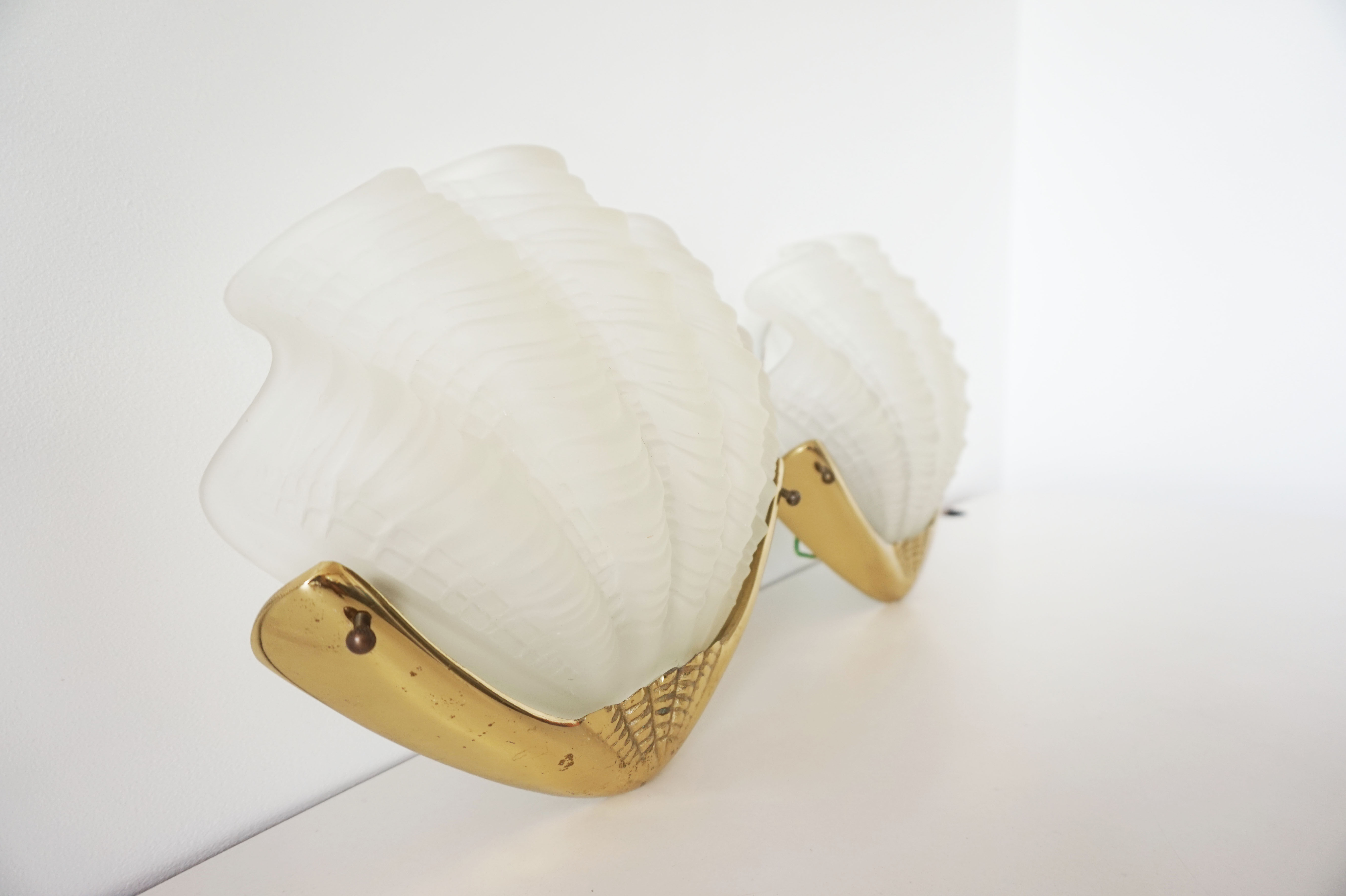 Pair of glass and gold metal shell sconces