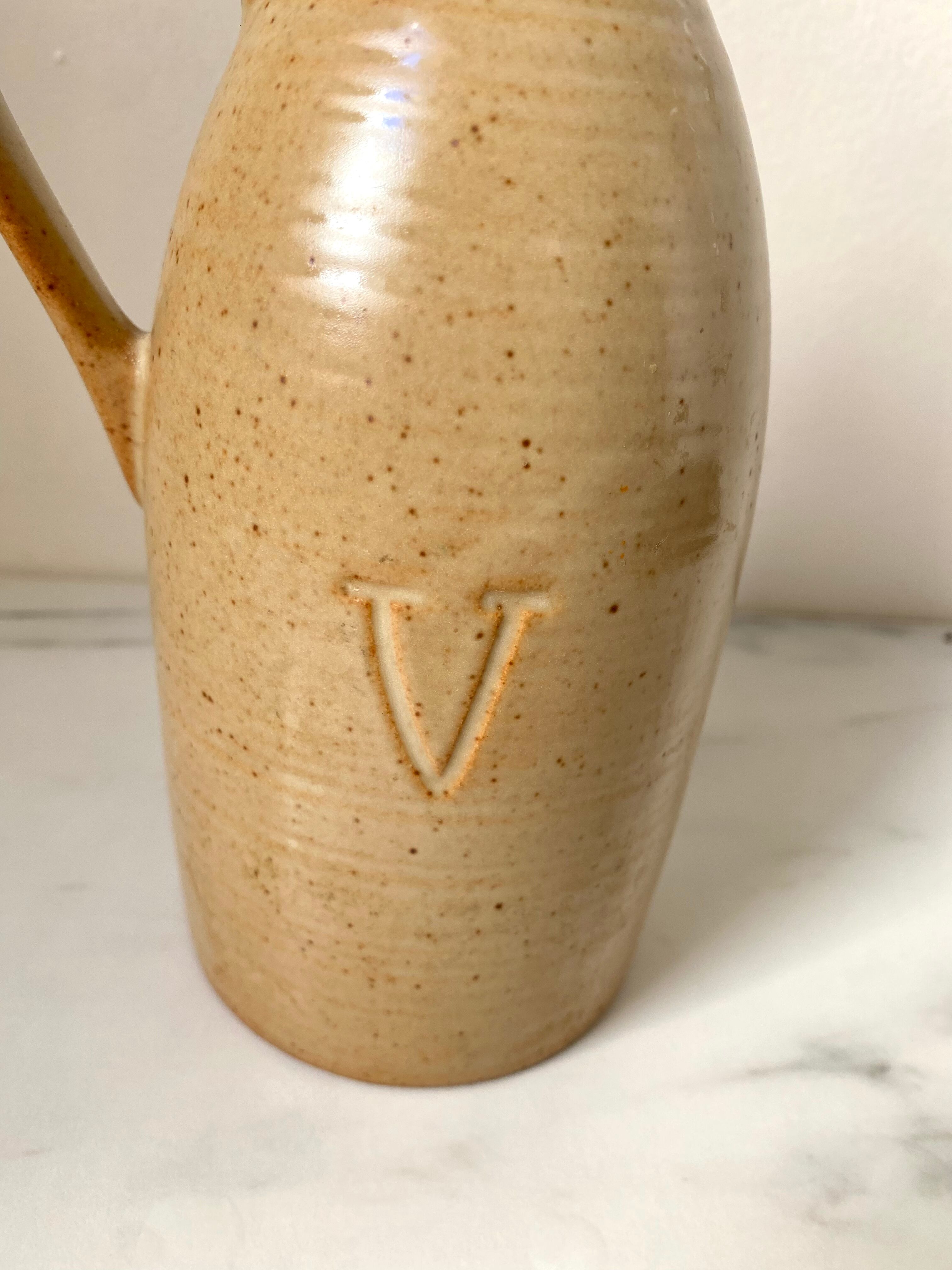 Old vinaigrier in beige sandstone signed Village de France