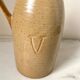 Old vinaigrier in beige sandstone signed Village de France