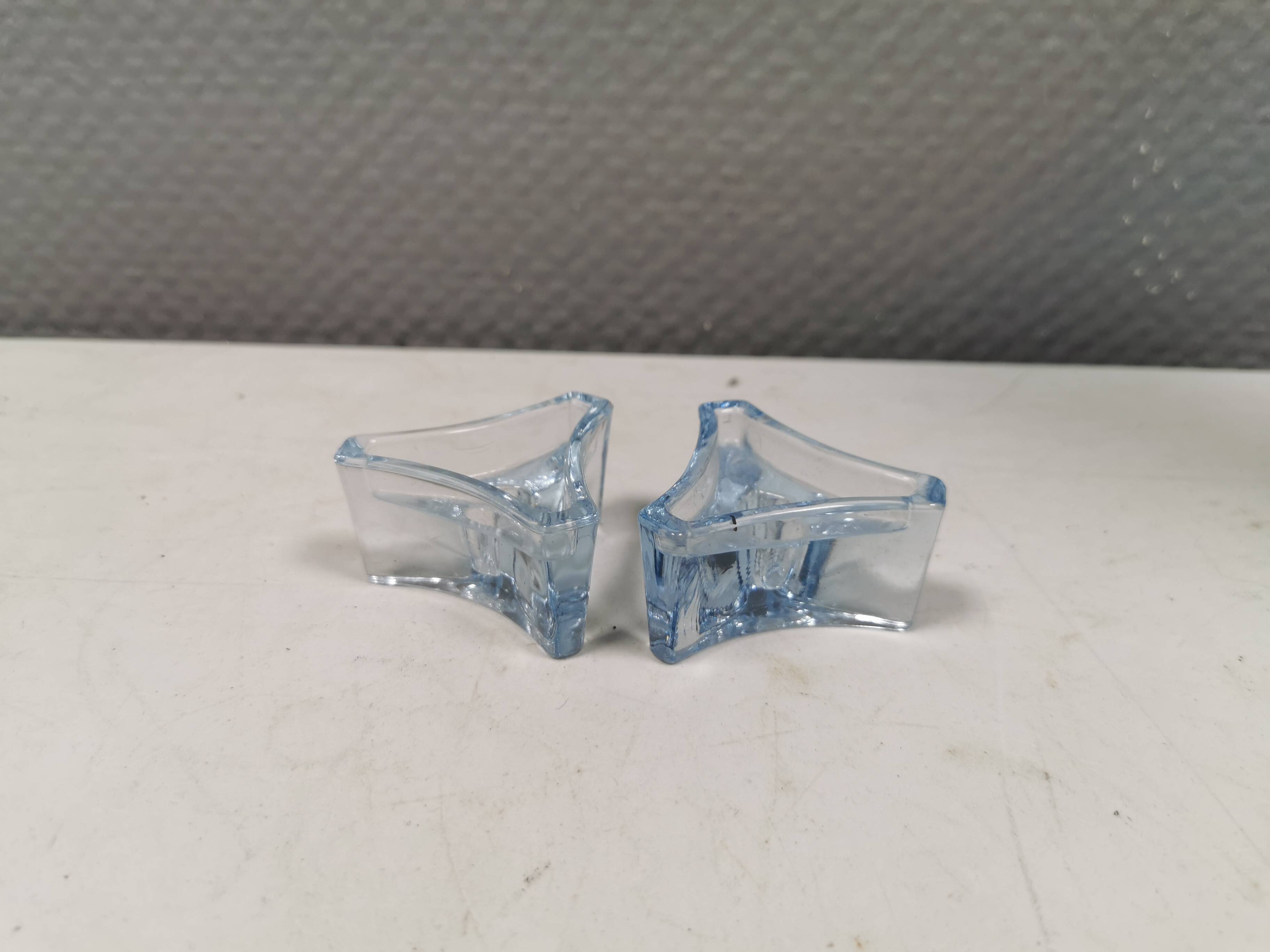 Two beautiful glass candle holders in translucent bluish glass.
