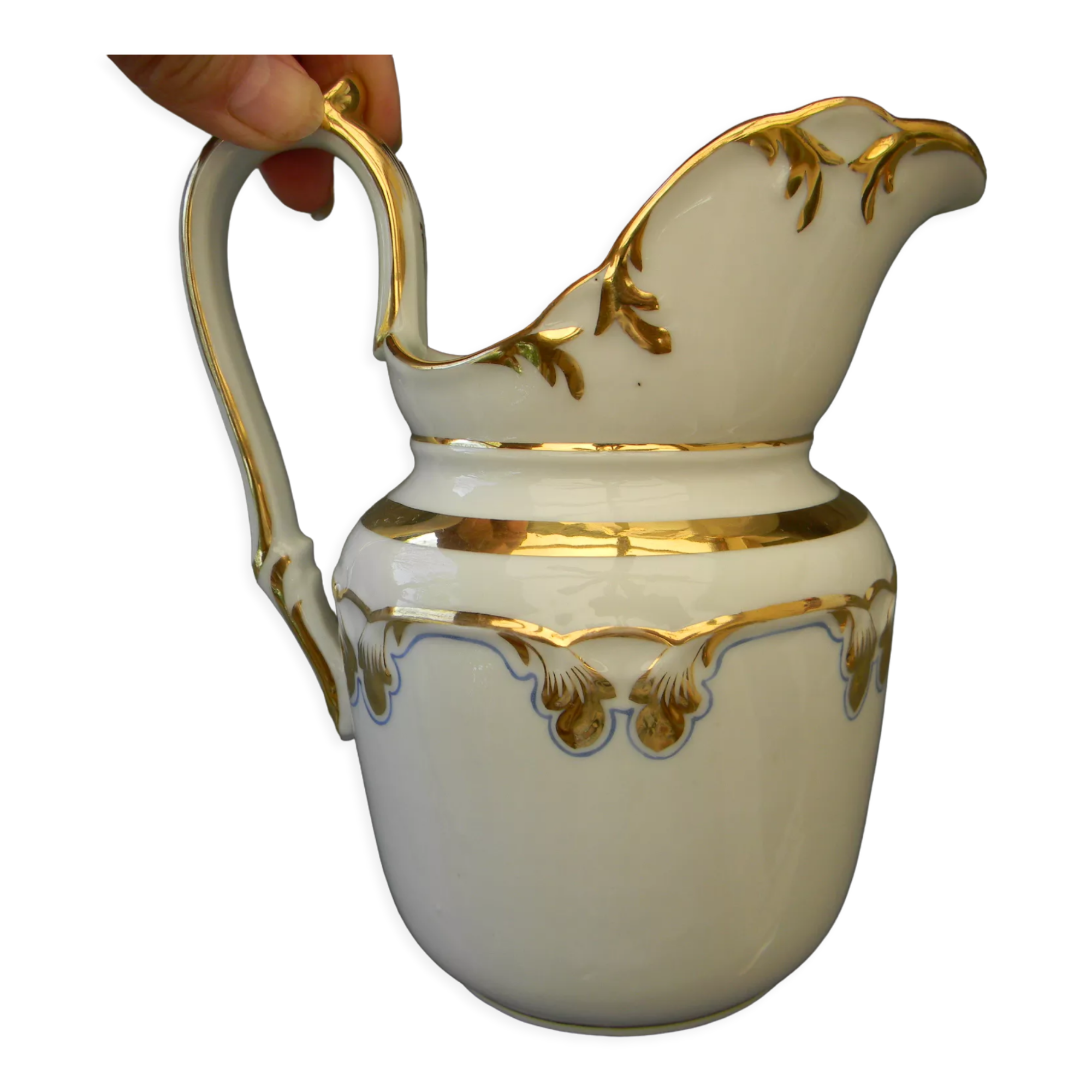 Milk jug or antique pitcher in white and gold porcelain.