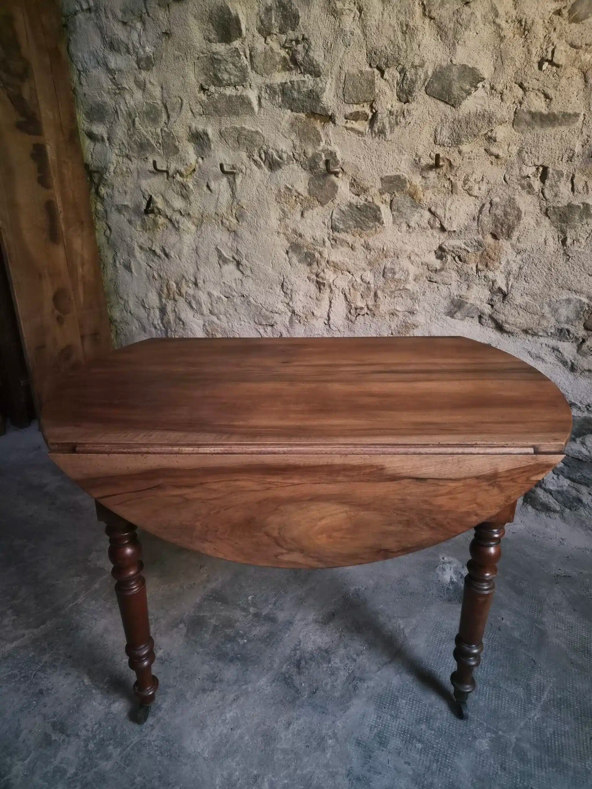 Antique drop-leaf dining table in walnut, France, circa 1900.