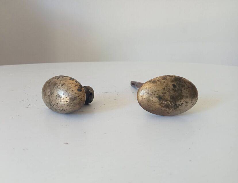Pair of antique oval door handles in solid gold-plated brass.