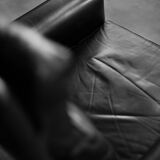 Mid-century danish modern minimalist black leather swivel armchair by georg thams, 1960s