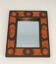 Miroir en céramique dans les tons orangés