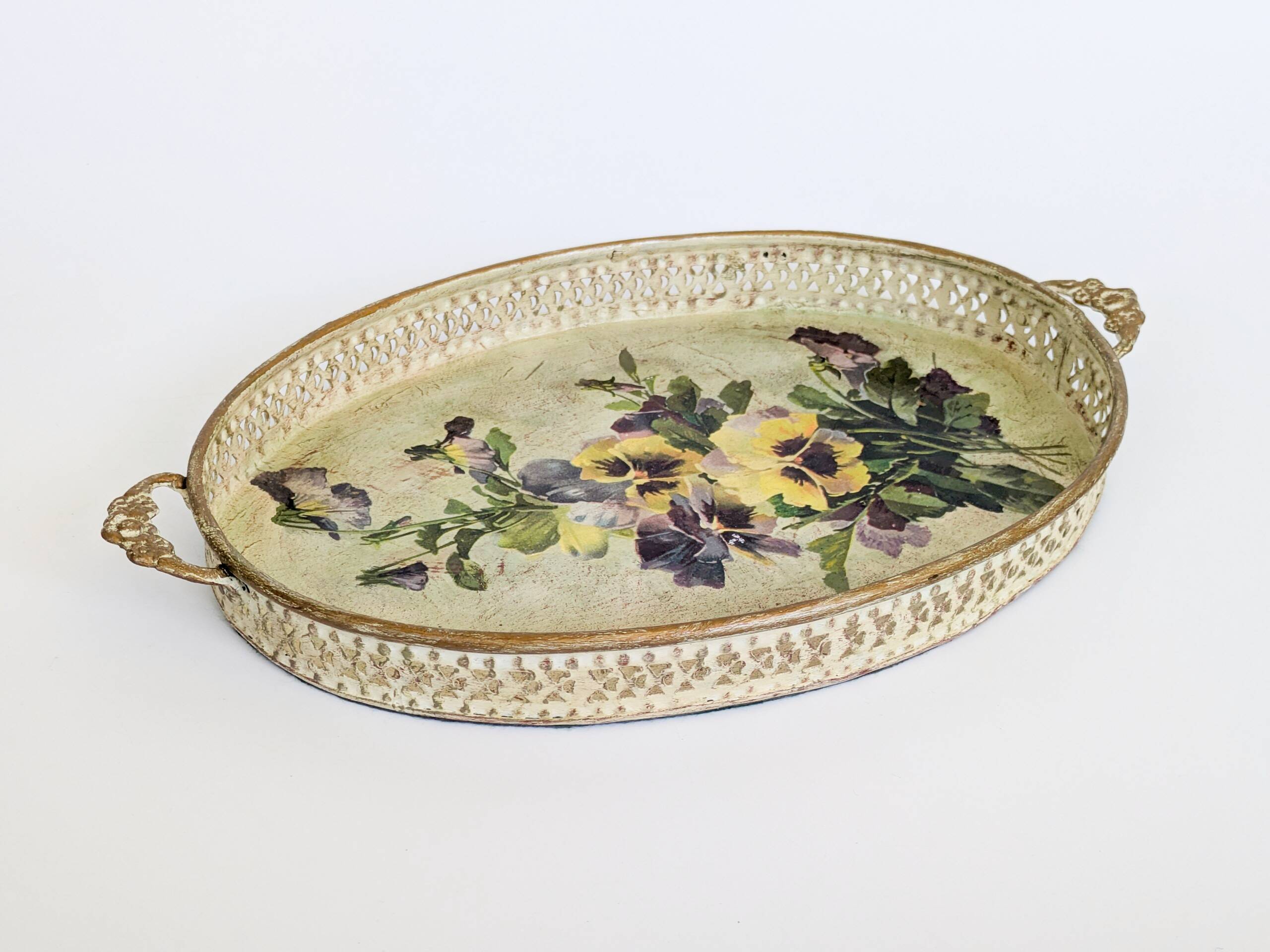 Oval metal decorative vintage tray with floral pattern.