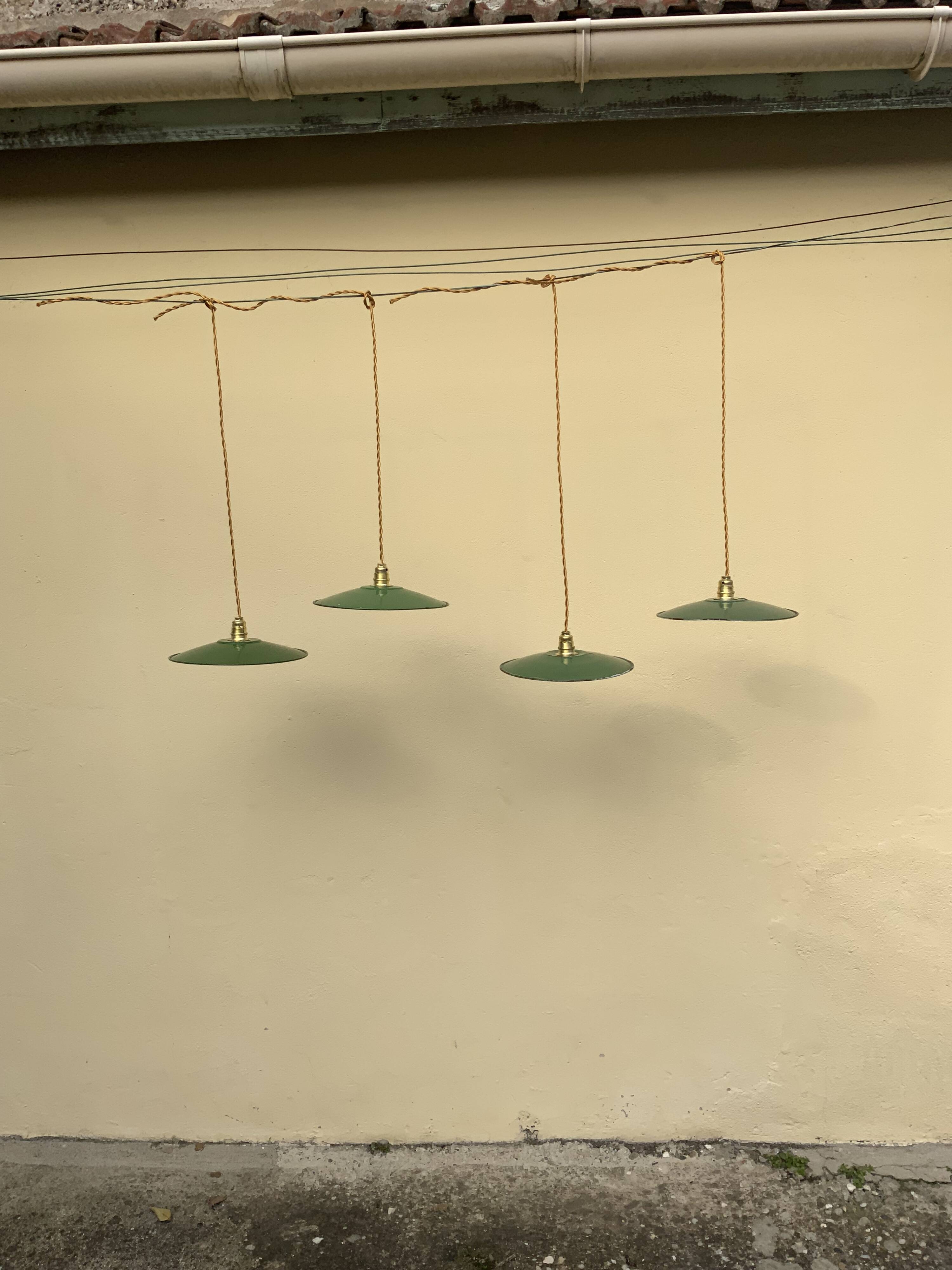 Vintage industrial enameled sheet metal pendant lights with golden wires, old green and white lampshade