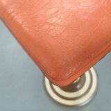 Old swivel orange sitting dentist stool