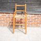 Old wooden high chair for children with straw.