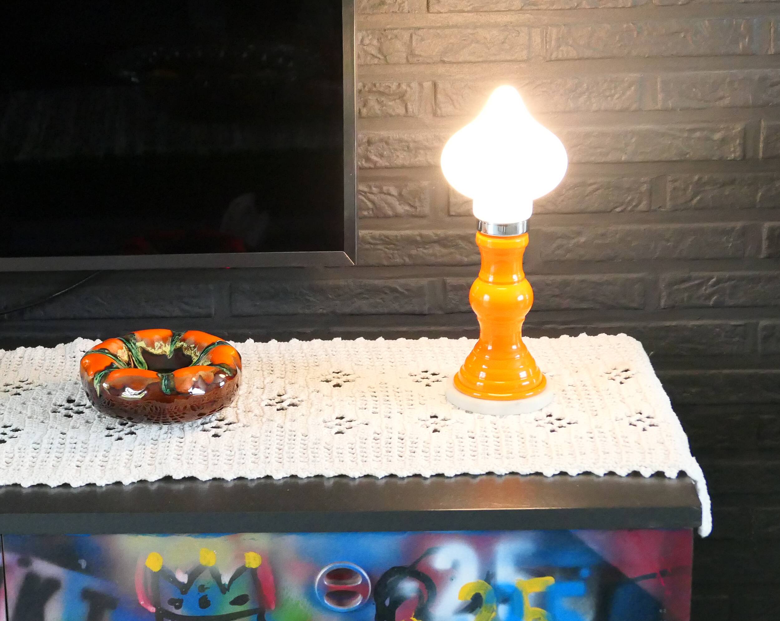 Table lamp or bedside lamp from the 1960s-70s in orange and chrome.