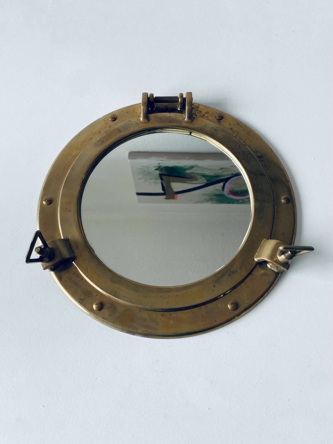 Porthole mirror in gilded brass