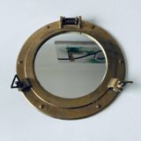 Porthole mirror in gilded brass