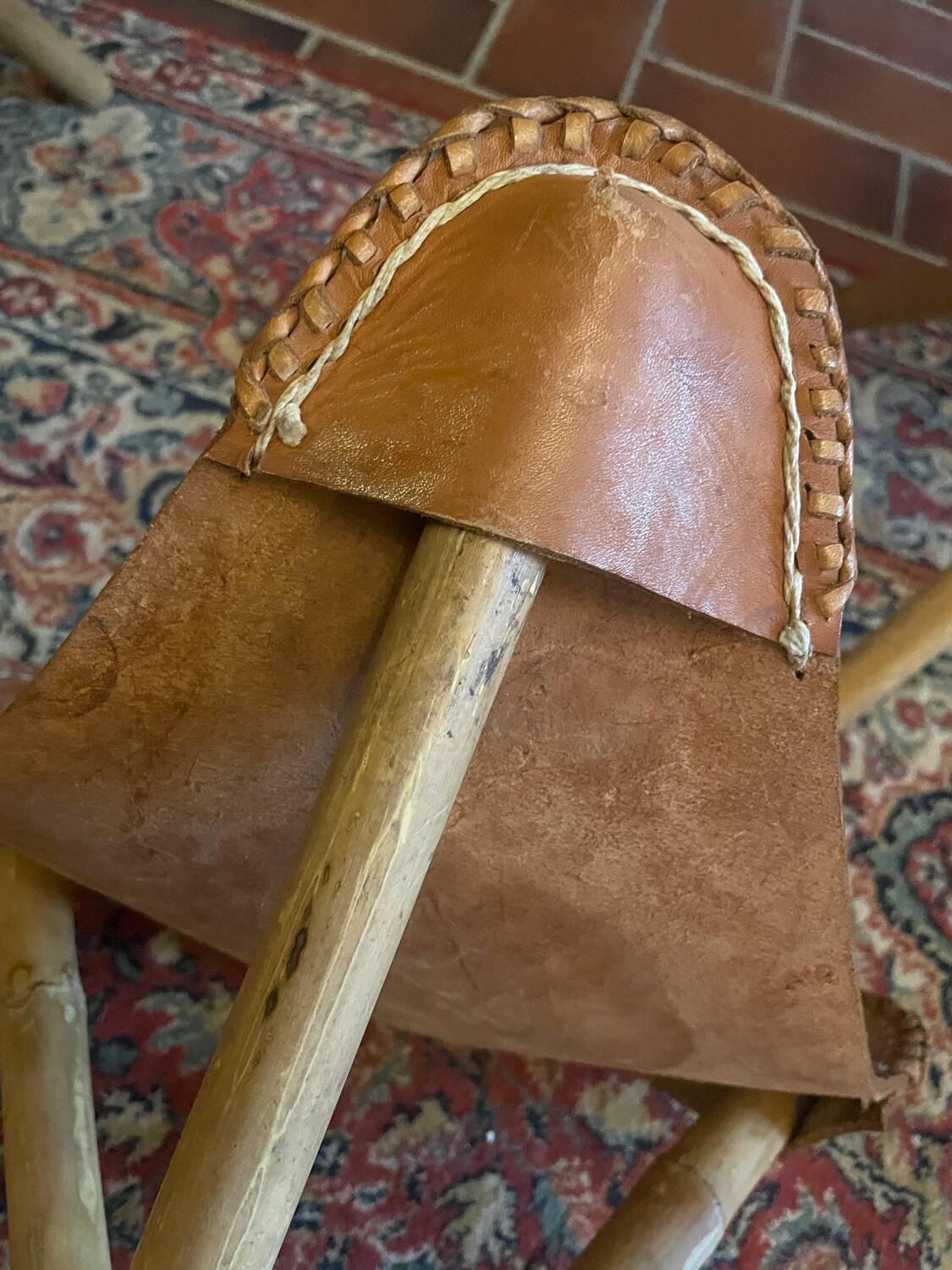 Vintage Mexican tripod stools in bamboo and leather.
