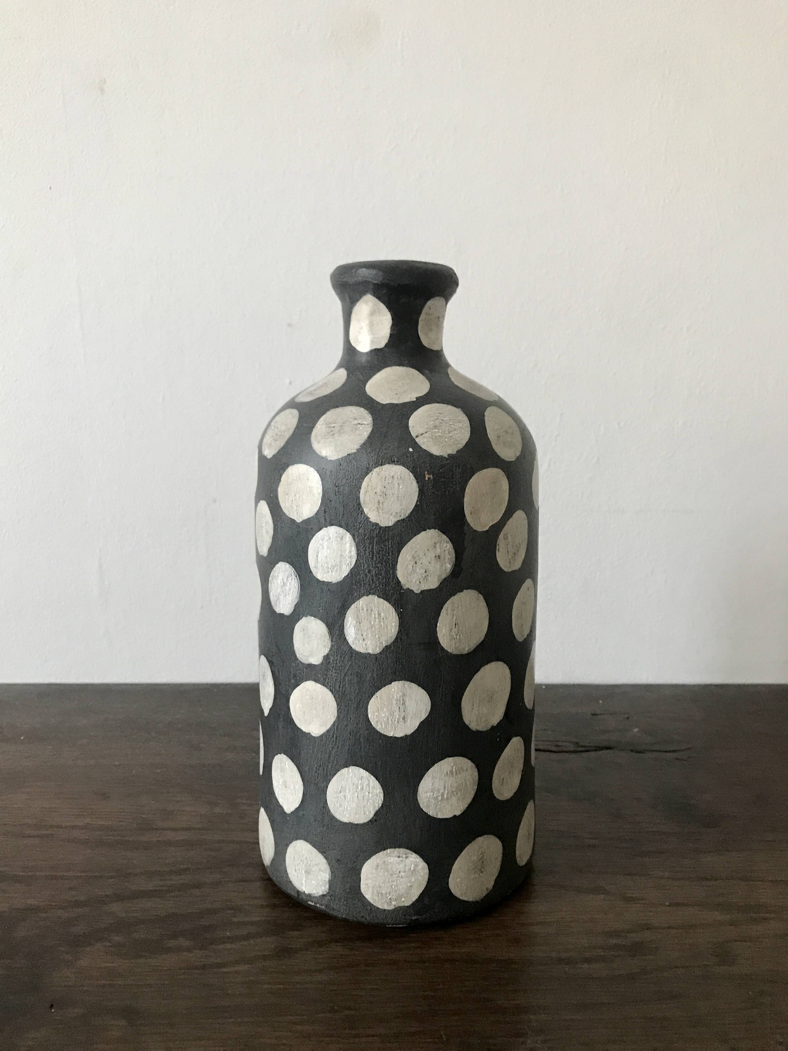 Terracotta vase painted with polka dots