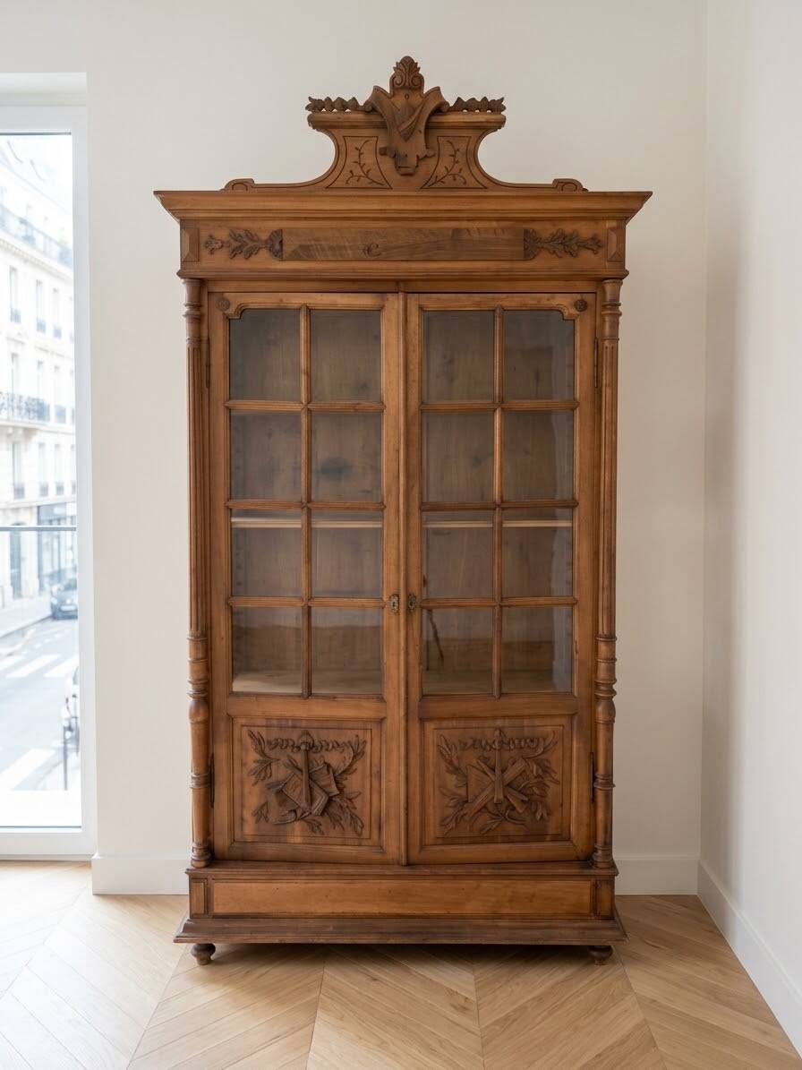 Antique wooden library with a carved pediment.