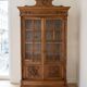 Antique wooden library with a carved pediment.