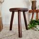 Old wooden tripod wooden farm stool made of wood