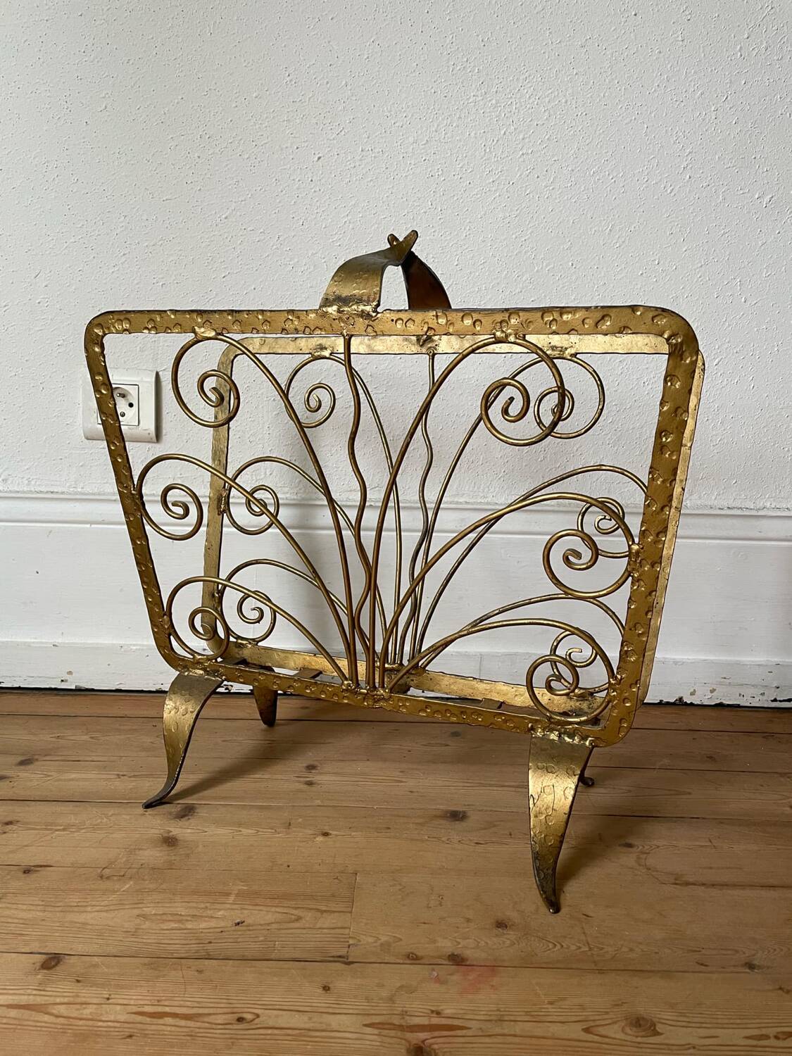 Vintage wrought iron magazine rack with gold butterfly design