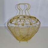 Old egg basket in yellow metal wire