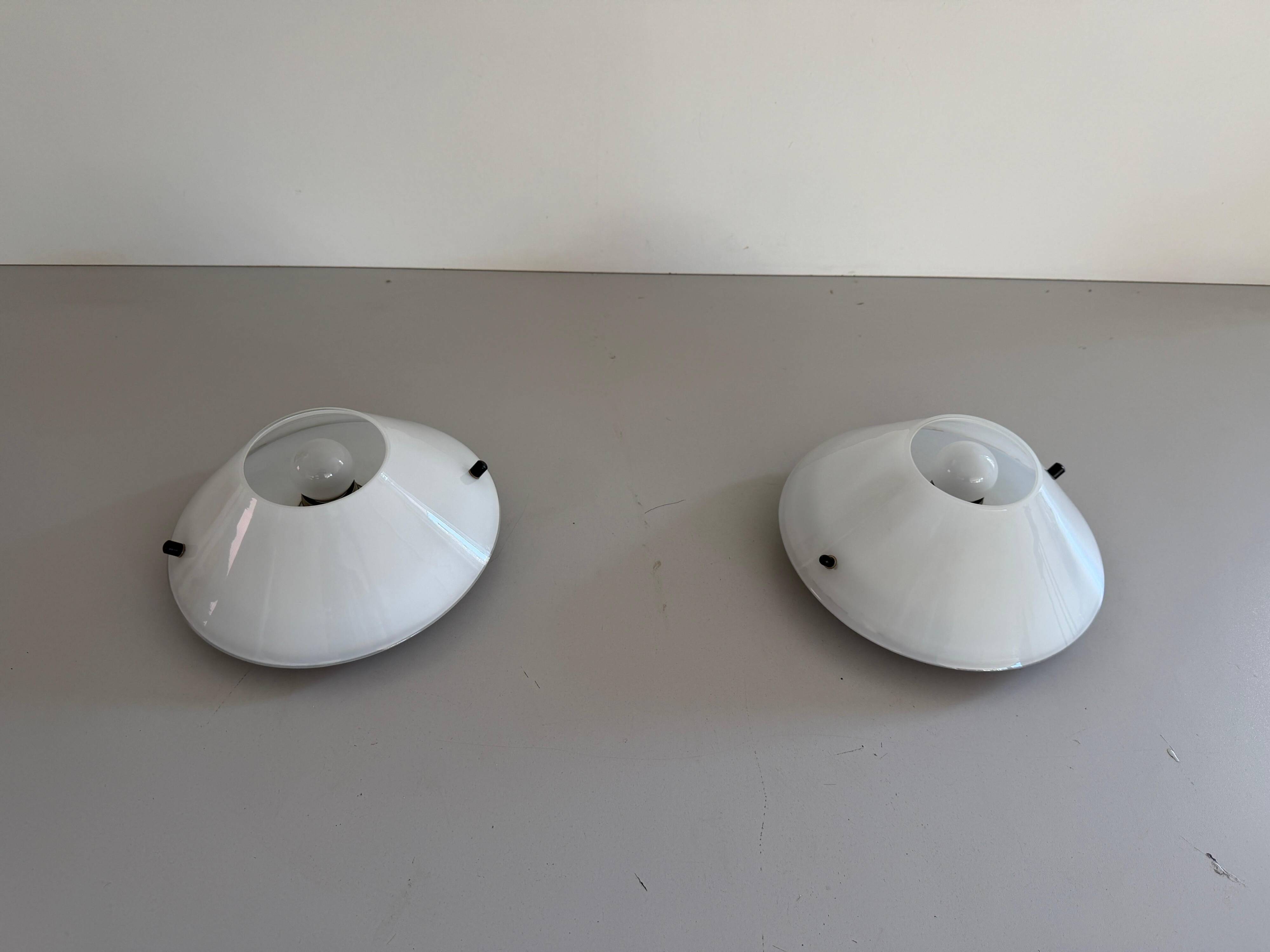 Pair of opal glass wall lights from the mid-century by Lamperti, 1960s, Italy.