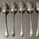 12 small Christofle Marly silver-plated spoons in the mascaron pattern.