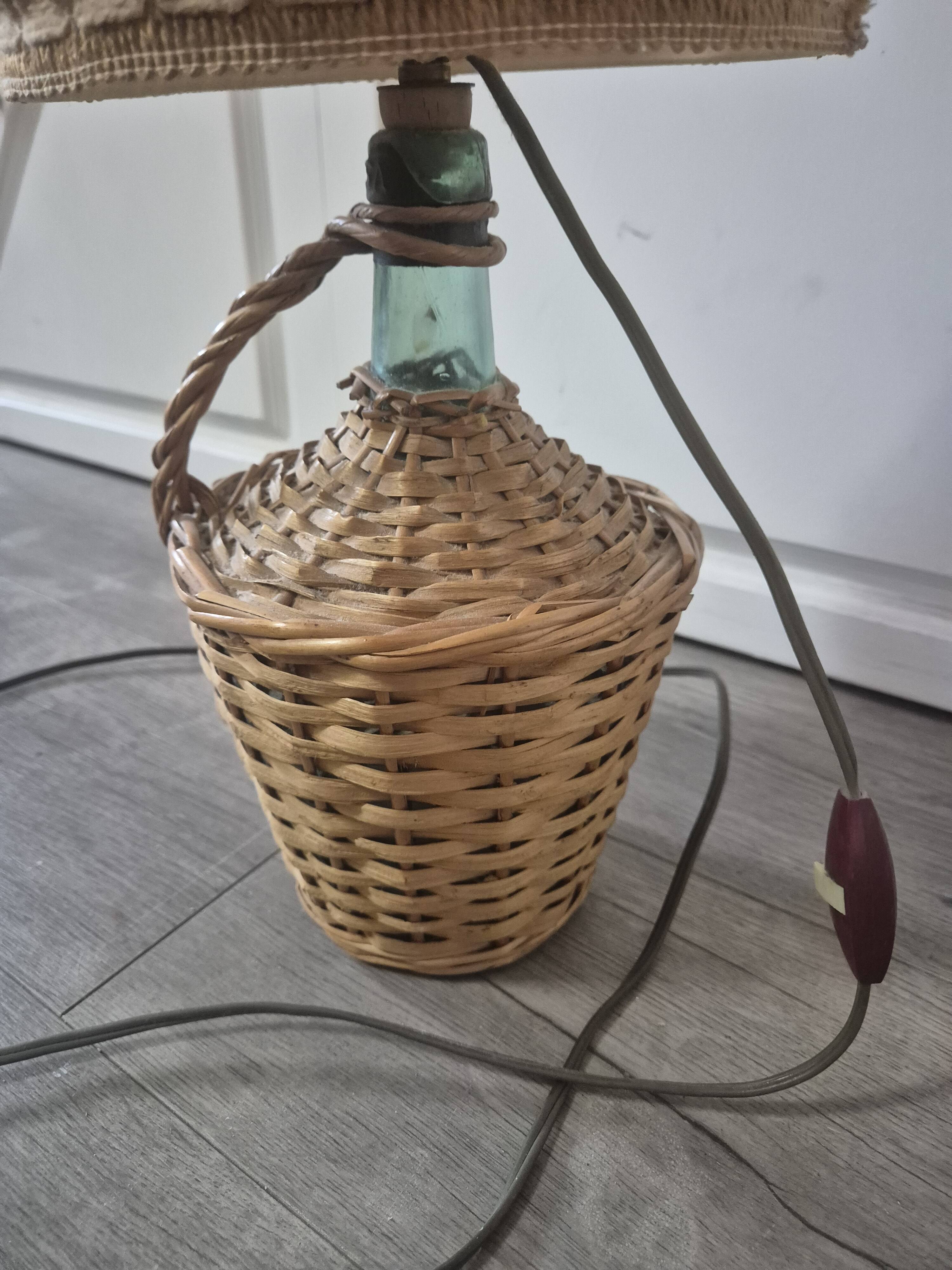 vintage table lamp dame jeanne covered in rattan wicker with a handle
