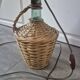 vintage table lamp dame jeanne covered in rattan wicker with a handle